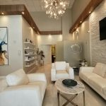 Corporate Interiors 1 - https://www.andyquinones.net Httpswww Andyquinones Net modern clinic lobby with white leather seating marble coffee table and a decorative chandelier overhead